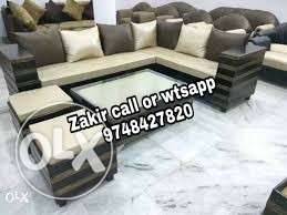 Cream and black padded l shape sofa