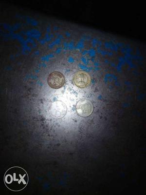 Four Silver-colored Indian Ruppee Coins
