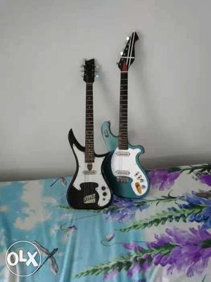 Two Black And Teal Electric Guitars