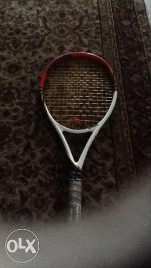 White, Red, And Black Tennis Racket