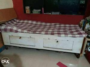 White Wooden Bed Frame And White And Red Checkered Mattress