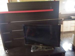 Black colored TV unit which is in good condition.