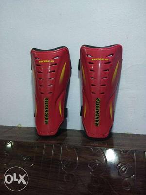 Pair Of Red-and-brown Manchester Knee Pads