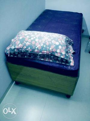 Blue Mattress And Brown Wooden Bed Frame