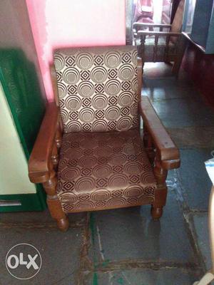 Brown Wooden Framed Brown Fabric Padded Armchair