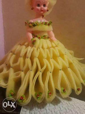 Female Doll Wearing Yellow And Green Dress