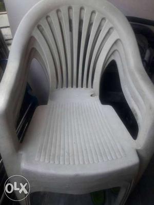 Four White Plastic Chairs