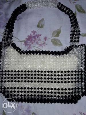 It is a handbag crystal bag with black and white