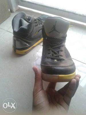 Pair Of Black-and-yellow Air Jordan Basketball Shoes