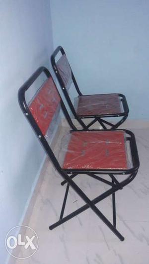 Two Black Metal-frame Red Folding Chairs