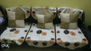 White, Brown, And Beige Floral Sofa With Throw Pillows