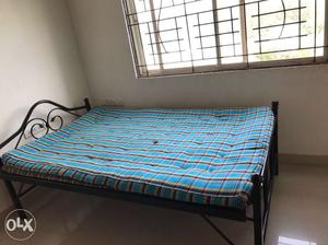 Black Steel Bed Frame With Blue And Black Plaid Mattress