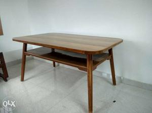 It's a strong unused table made out of teak wood