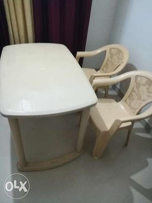 Plastic Dining table and two chairs.