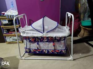 Baby's White, Purple, And Pink Floral Cradle