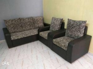 Black 3 seater sofa with 2 chairs.