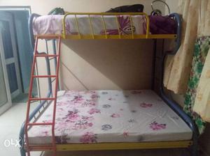 Black Metal Bunk Bed With White And Red Floral Mattress