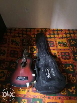 Maroon And Black Acoustic Guitar With Black Case