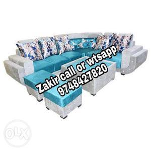 Blue and white padded l shape tufted sofa with