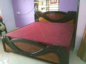Brown And Black Wooden Bed With Red Mattress