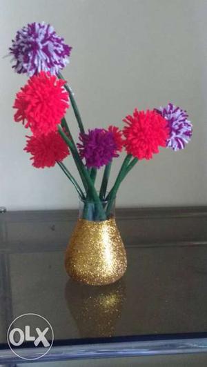 Three Artificial Red And Purple Petaled Flowers With