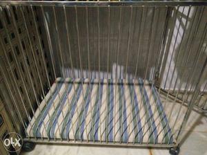 Gray Metal Wheeled Cage