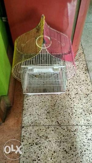 White, Pink, And Yellow Metal Bird Cage