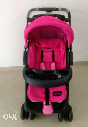 Baby's Pink And Black Stroller