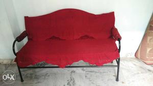 Black Metal Framed Red Padded Sofa