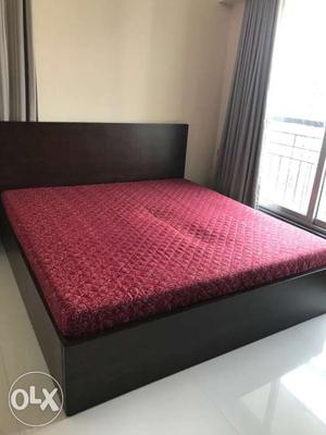 Black Wooden Bed Frame With Red Mattress