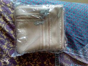Brand new stylish cream color sling bag with