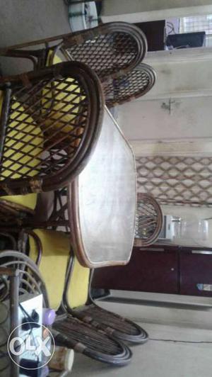 Cane dinning table of 6 chair with pillows in