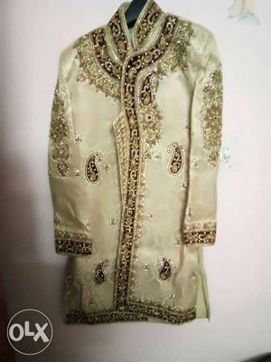 Gold-colored Sherwani Suit with red duptta