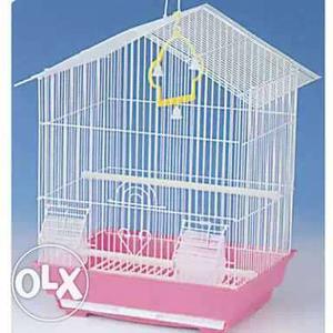 Pink bird cage with two birds and nest also