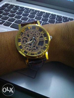Round Gold Skeleton Watch With Brown Leather Strap
