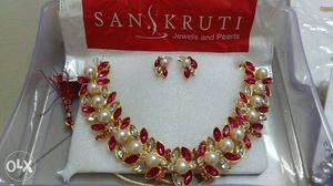 Sanskruti Pearl And Ruby Embellished Necklace And Earrings