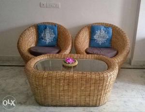 Two Brown Padded Wicker Chairs With Oval Table Set