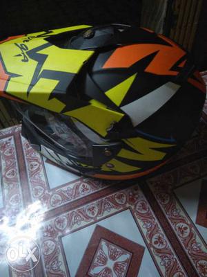 Black, Orange, And White Motocross Helmet