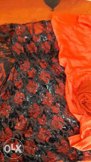 Orange And Black Floral Textile