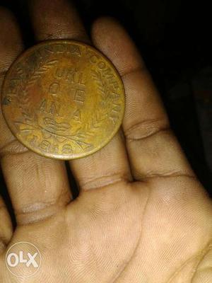 Round Gold-colored One Anna Coin