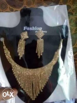 Gold-colored Bib Necklace And Chandelier Earrings Set
