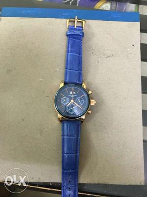 Round Gold Chronograph Watch With Blue Leather Strap