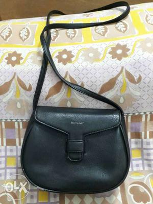 Used Black sling bag. In good condition except