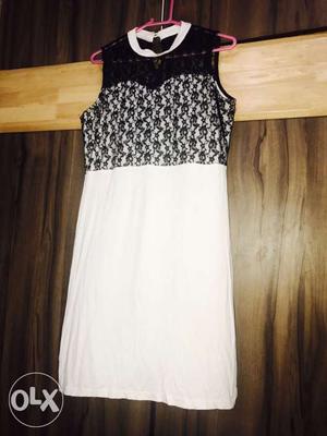 A white and black coloured cotton dress with a