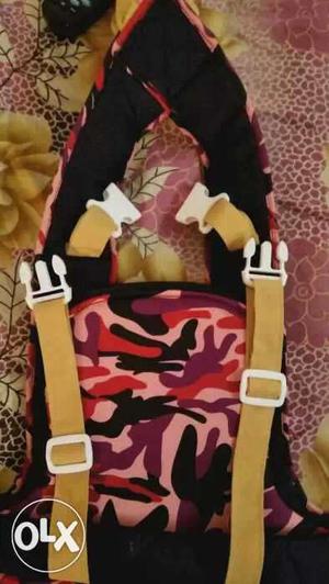 Baby's Black, Yellow, Red, And Purple Carrier