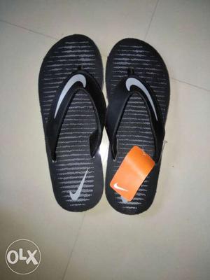 Black-and-white Nike flip flop