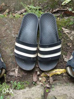 Pair Of Black And White Slide Sandals