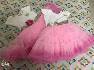Twin baby girl clothing includes pink and pretry