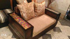 Beige Padded Couch With Brown Wooden Frame