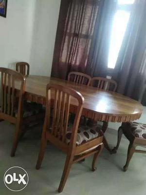 Oval Brown Wooden Dining Table And Chiars